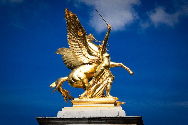 Image, Golden statue of sword-wielding person beside a winged horse