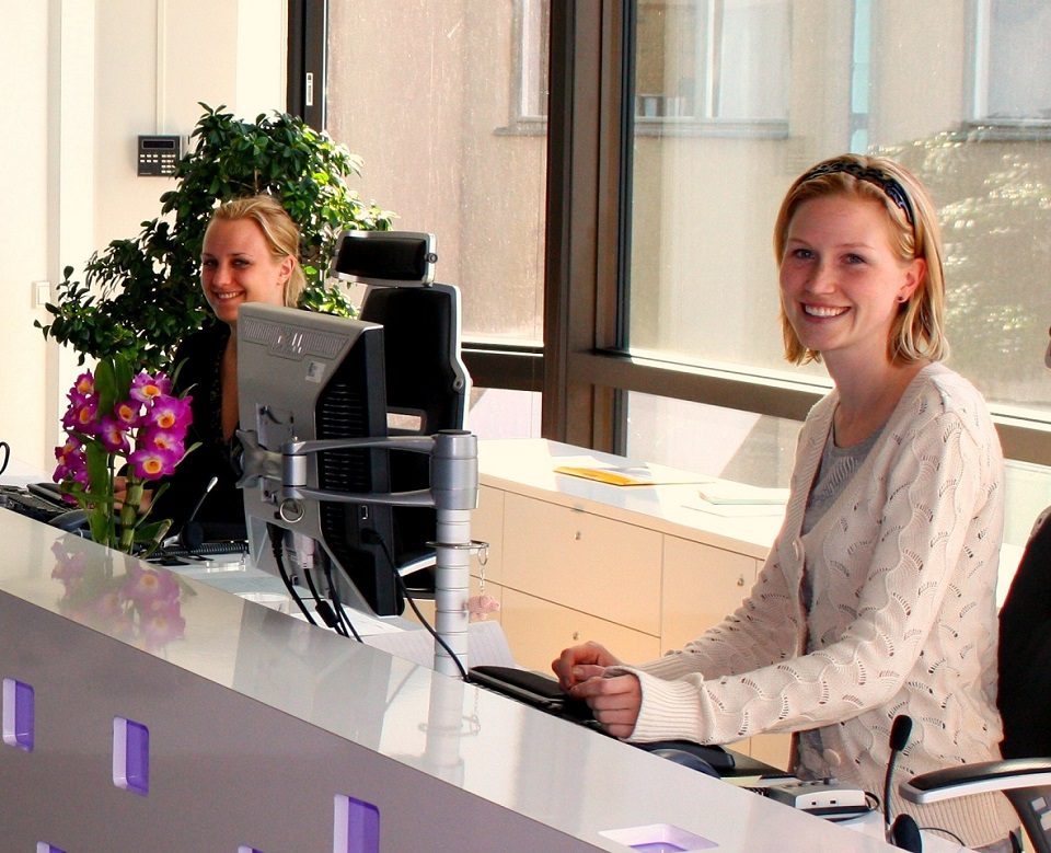 Image, receptionists at desk.
