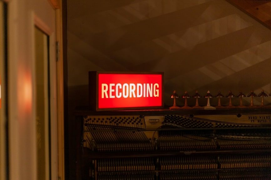 red and white neon signage that says ‘recording’.